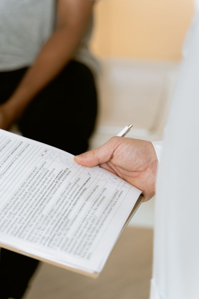 Crafting Captivating Headlines: Your awesome post title goes here A healthcare professional reviewing a patient's medical chart during a consultation.